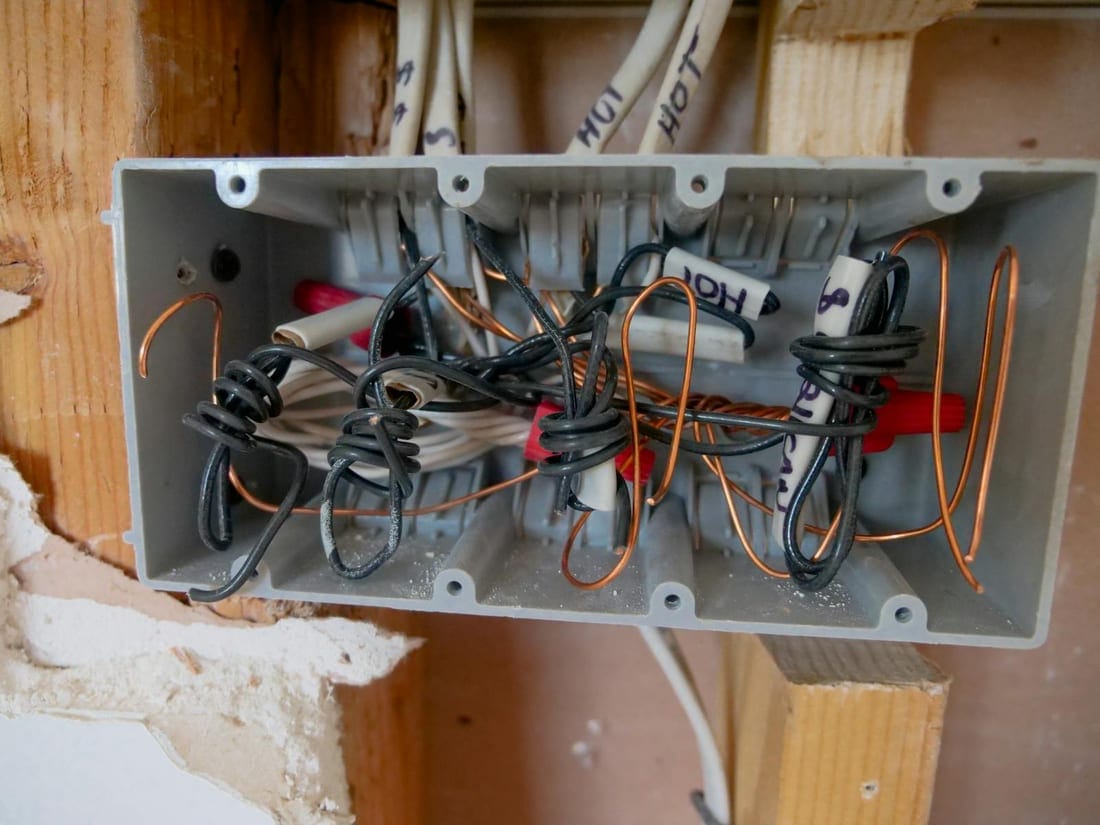 Open electrical switchboard with tangled wires - the kind of decades-old installation typical inside older Shahgunj buildings, which we replace with modular RCCB boards
