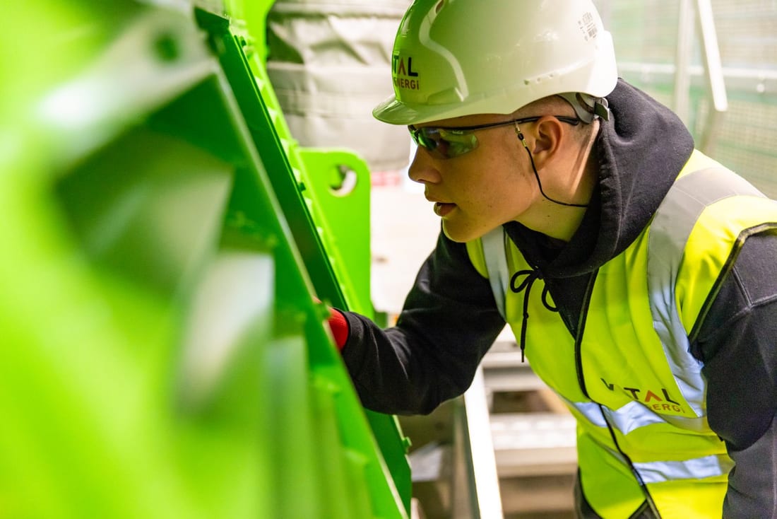 Factory worker in a safety helmet on the production floor - the kind of facility where a structured electrical AMC program prevents unplanned production downtime in MIDC factories