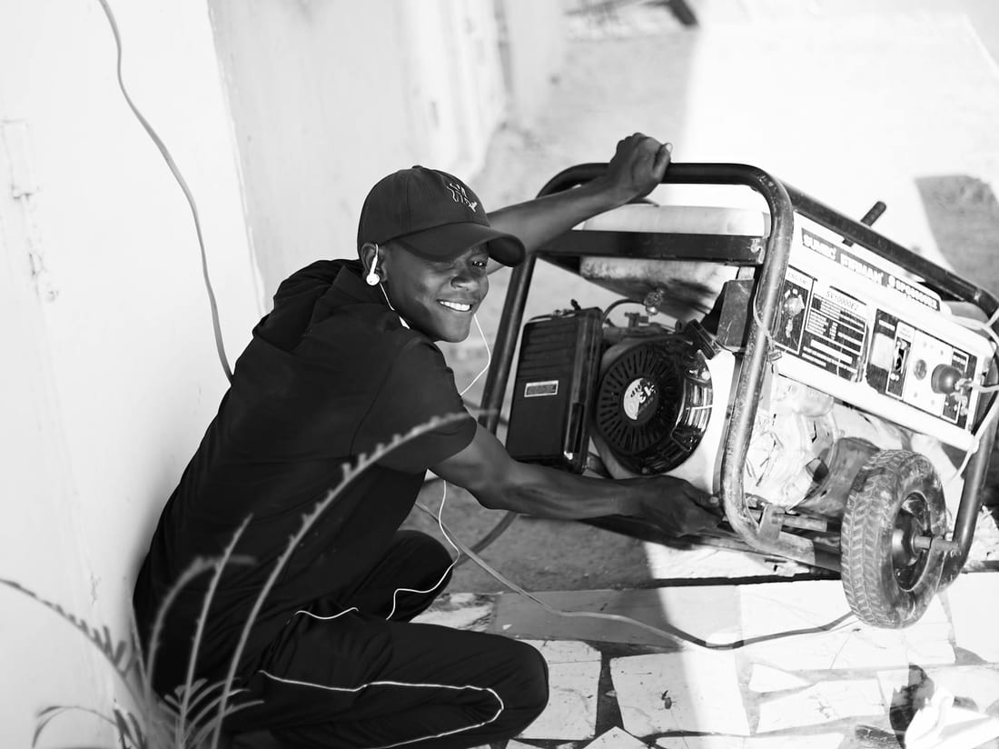 Man operating a portable generator as backup power for a home or shop - inverter vs generator selection guide by Shaats Electrical, Chh. Sambhajinagar (Aurangabad)