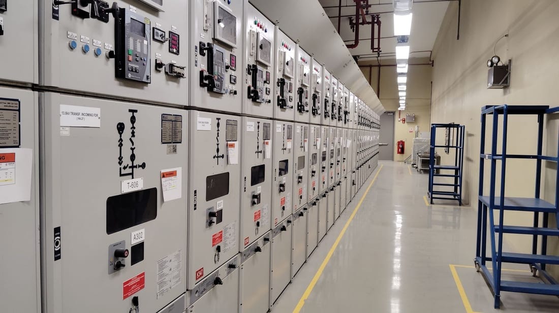Long row of industrial control panels inside a small-factory electrical control room - typical Waluj / Chikalthana / Shendra MIDC setup that Shaats Electrical maintains under AMC