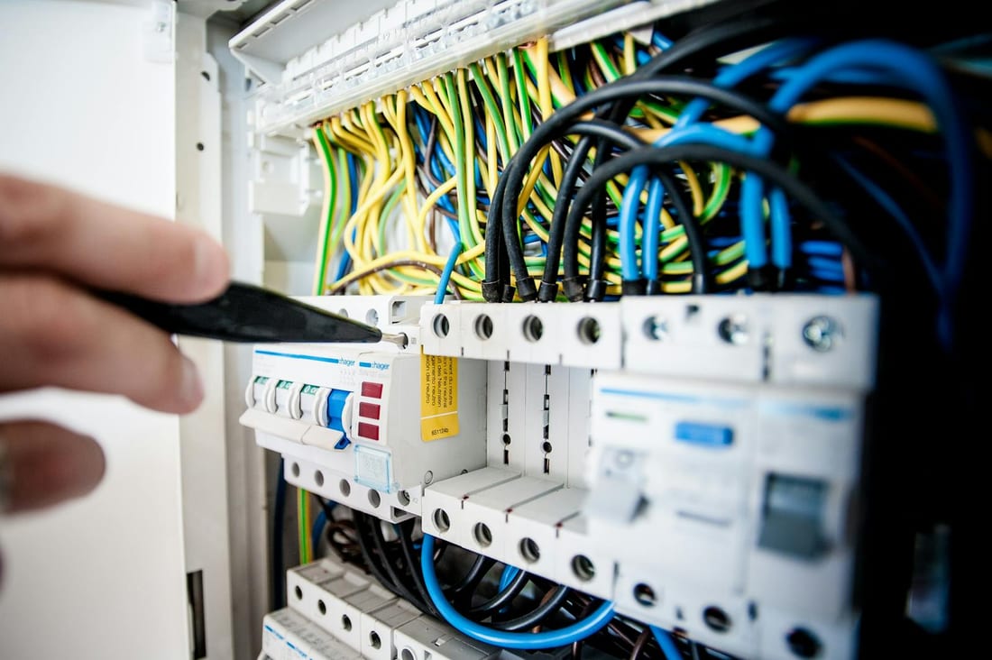 Close-up of wiring terminals inside an Indian distribution board showing loose and damaged connections
