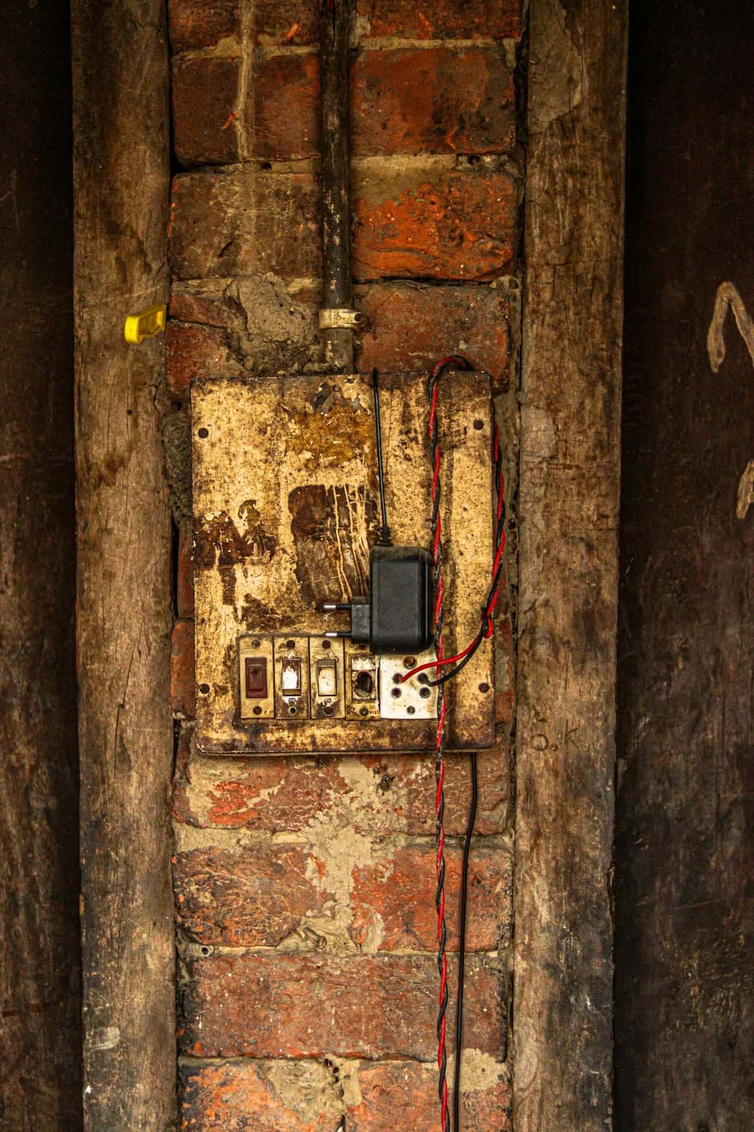 Vintage rewireable fuse box on a brick wall - the older protection device that has now been replaced by MCB + RCCB