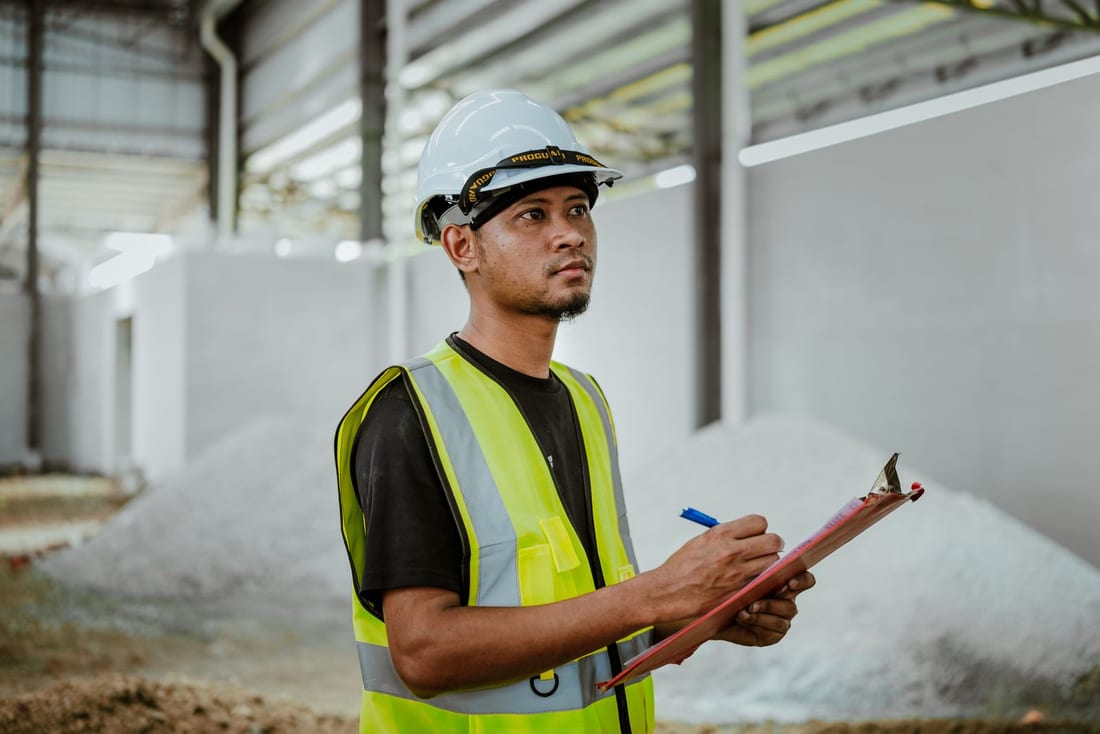 MIDC factory maintenance technician with clipboard -- written visit report and inspection checklist are the core of a genuine electrical AMC