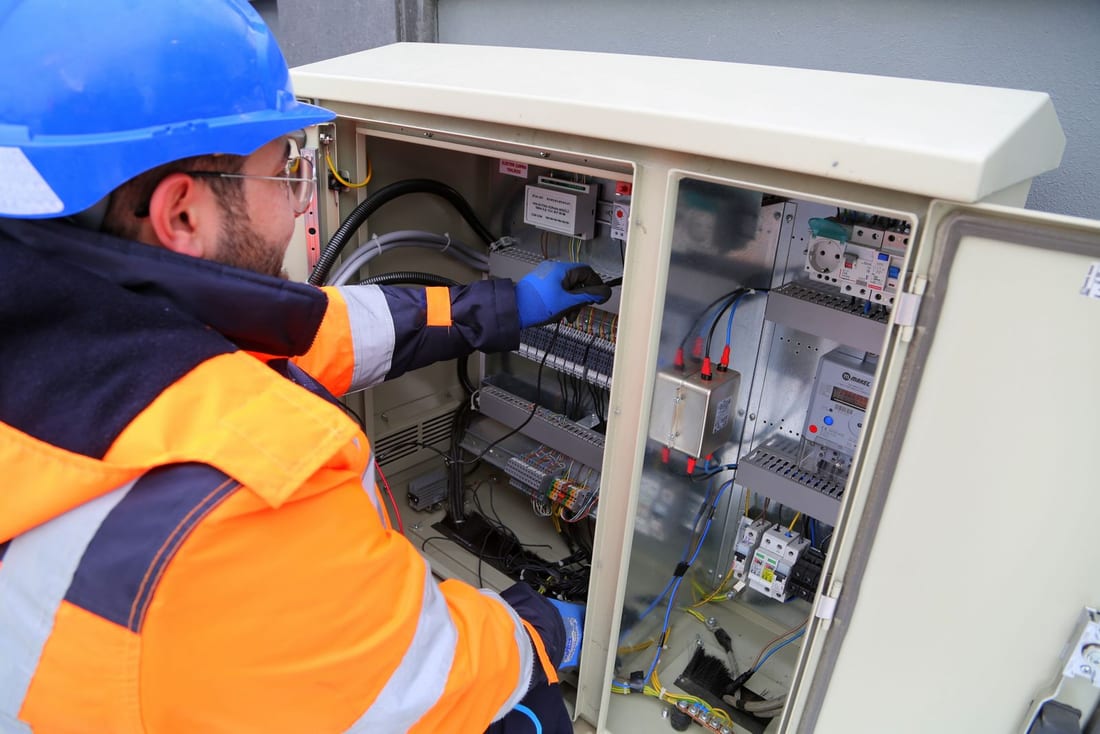 Technician working systematically inside an industrial electrical panel during a scheduled preventive maintenance visit - electrical AMC for Shendra MIDC and AURIC factories in Chh. Sambhajinagar