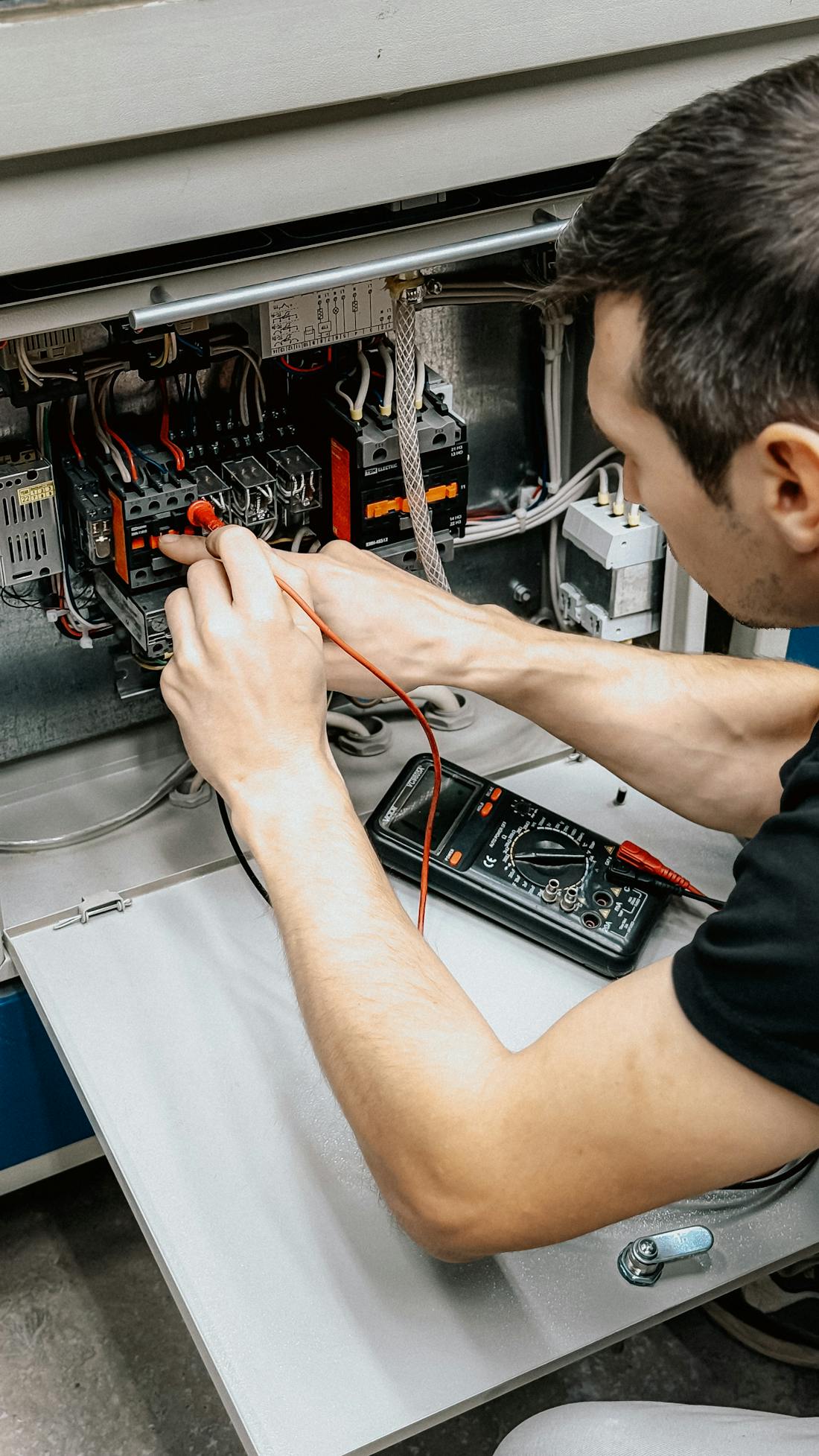 Shaats Electrical technician using a multimeter to test a control panel — professional electrical inspection in Aurangabad